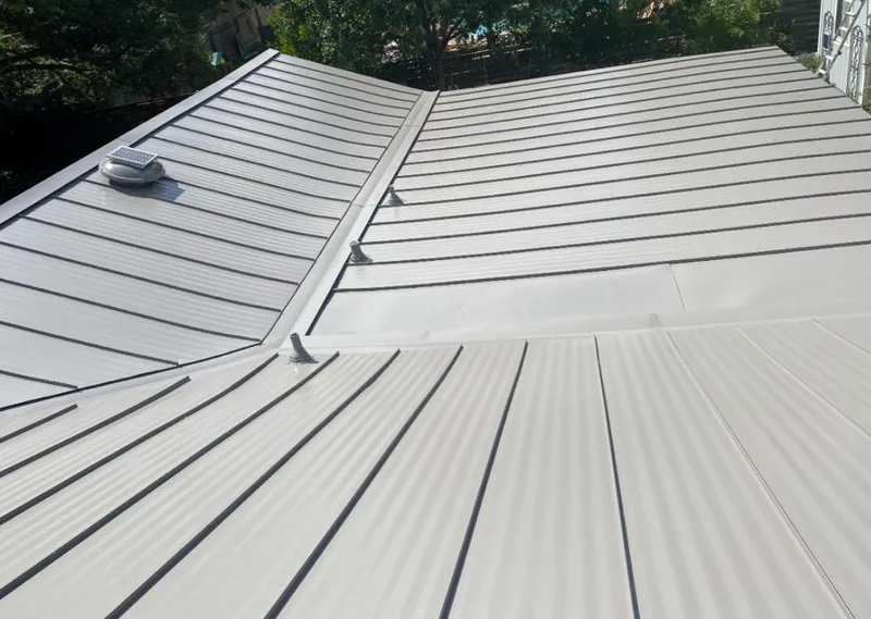 Solar attic fan installed on a metal roof for Roof Ventilation in Zion